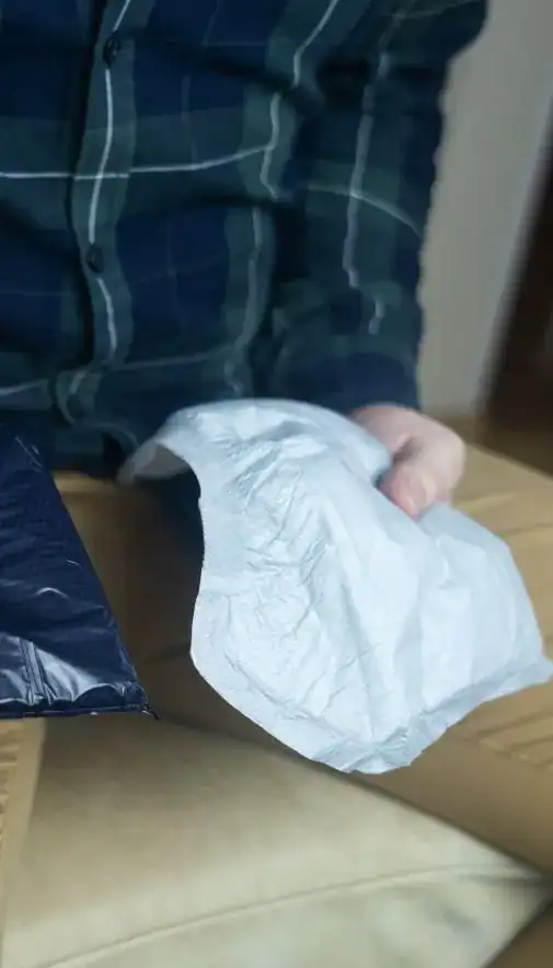 Image of man holding incontinence pads as part of overactive bladder treatment Milton Keynes