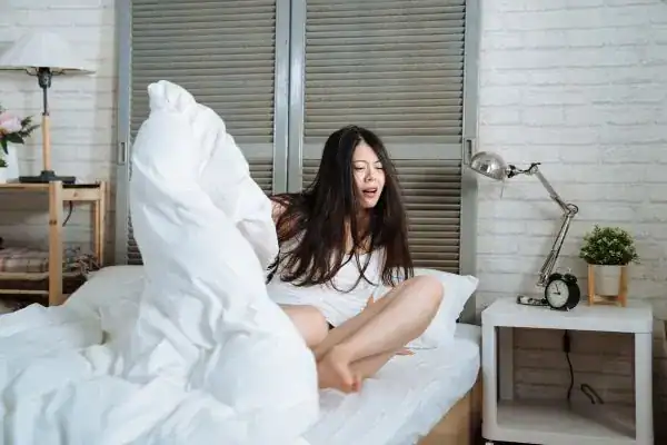 Image of woman getting up because of nighttime leaks Milton Keynes